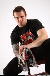 Alex Sitting With Pistol Pose